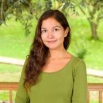 Profile picture of Ipek Leni Candan, against a backdrop of green fields and leaves from a tree.